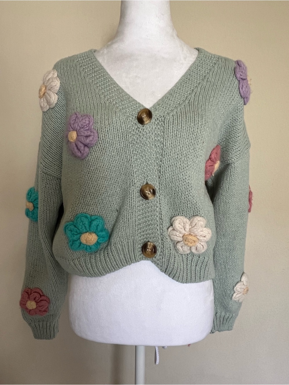 Luna Ivy light green knit button-up cardigan featuring 3D crochet flowers